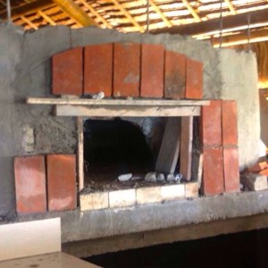 Partially done wood fired oven, opening view with bricks design.