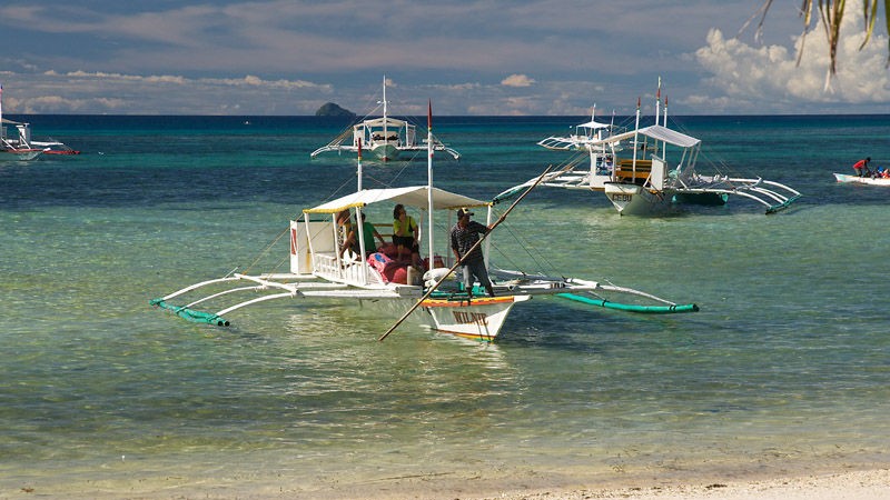 Boat rigger docks in front of Logon Beach where Kokay's Malapascua Dive Resort is located.